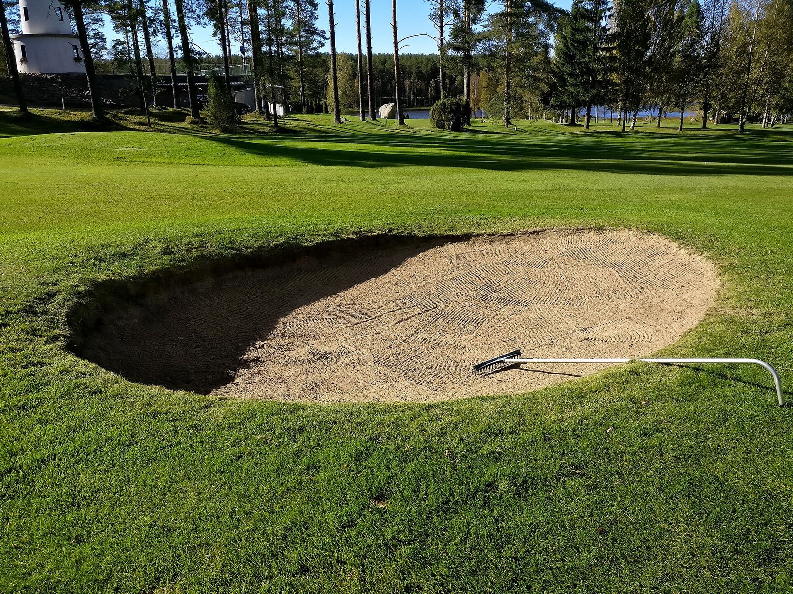 A deep sand bunker guarding a green